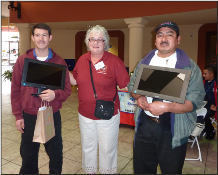 Chicana Latina staff giving equipment to 2 clients