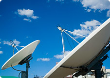 sat-dish Satellite Dishes under a blue sky with small clouds in the background