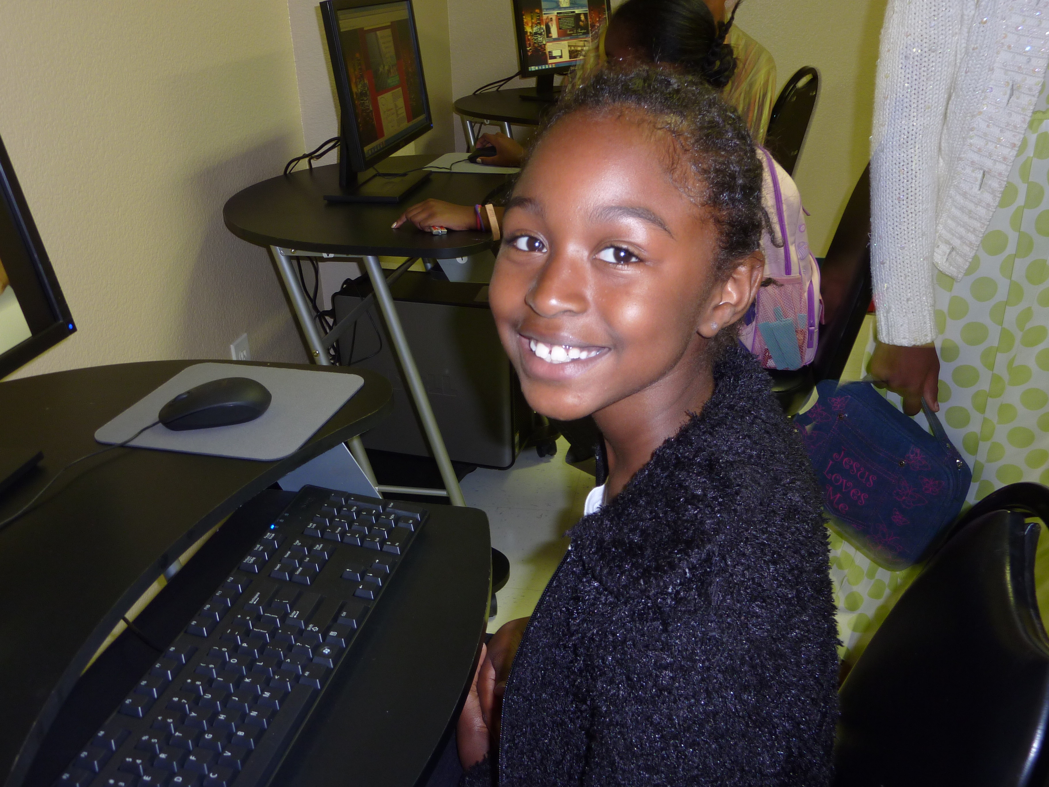 Girl at Computer training with a huge smile