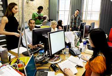 Open workspace with people collaborting on computers